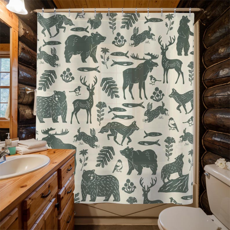 A shower curtain with a repeating pattern of forest animals in dark green on a cream background. The woodland design includes bears, deer, rabbits, foxes, birds, fish, and plants. The curtain has a whimsical log cabin aesthetic.