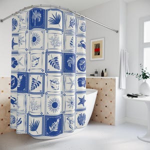 May include: A blue and white shower curtain with a repeating pattern of botanical and nautical illustrations. The design includes images of palm trees, leaves, lemons, starfish, and the sun. The curtain is hanging in a bathroom.