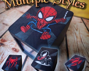 May include: Black wooden display box featuring a cartoon Spider-Man design. The box has a clear front and is accompanied by smaller boxes with Spider-Man and Venom graphics. The text "Multiple Styles" is at the top.