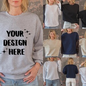 Puede incluir: Una colección de diez sudaderas en varios colores, incluyendo gris, blanco, negro, beige y azul. Las sudaderas presentan un diseño sencillo con el texto "YOUR DESIGN HERE" impreso en negro en la parte delantera.