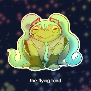 May include: A digital illustration of a green frog with light green hair and a matching outfit. The frog is sticking its tongue out and wearing headphones. The text "the flying toad" is at the bottom.