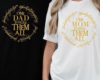 May include: Two t-shirts with a gold design inspired by the Lord of the Rings. One shirt says "One Dad to Rule Them All" and the other says "One Mom to Rule Them All".