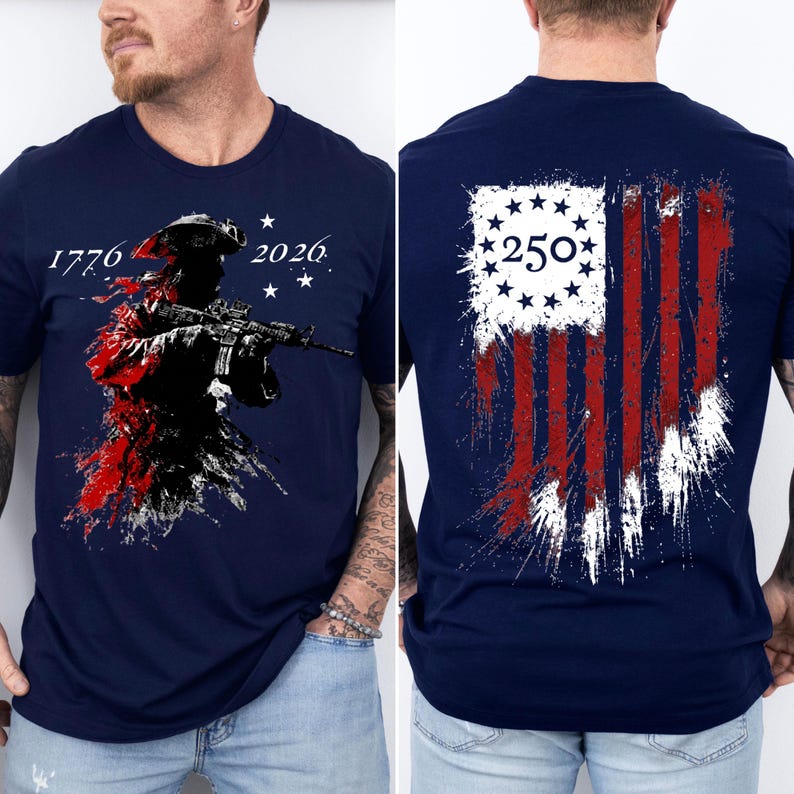 May include: A navy blue t-shirt featuring a front graphic of a soldier in a tricorn hat holding a rifle with the text 1776 and 2026. The back graphic displays a distressed American flag design with a circle of stars and the number 250 in the center.