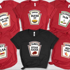 May include: Red and black t-shirts with sauce-themed graphics. The shirts feature labels with text like "Yum Yum Sauce," "Queso Dip," "Tajin," "Spicy Salsa," "Steak Sauce," and "Hot Sauce." The shirts are a fun, food-themed apparel.