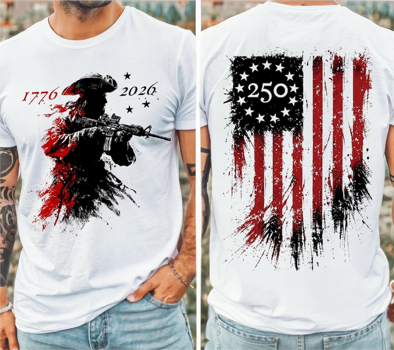 May include: A white t-shirt featuring a graphic on the front of a soldier in a tricorn hat holding a rifle with the text 1776 and 2026. The back displays a distressed American flag design with a circle of stars and the number 250 in the center.