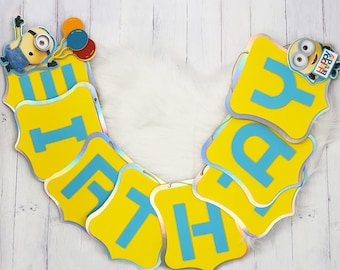 May include: A yellow and blue banner with the word "Happy Birthday" spelled out in large, blue letters. The banner is decorated with a small, cartoon minion character.