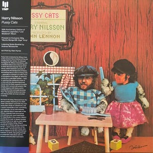 May include: Album cover for Harry Nilsson's "Pussy Cats" featuring a whimsical illustration of two figures at a table. The album title and artist's name are displayed in a framed cross-stitch design. The cover has a vintage aesthetic.