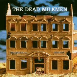 May include: A model of a dilapidated building with the words "The Dead Milkmen" above the windows and "Metaphysical" and "Graffiti" on the lower level.