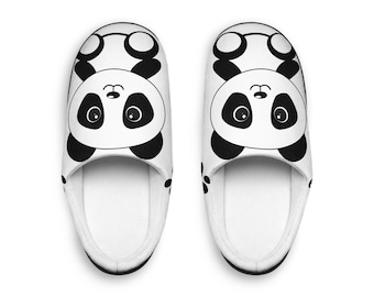 May include: A pair of white slippers featuring a black and white panda bear face graphic on the top. The slippers have a rounded toe design, a white interior lining, and a clean, simple aesthetic with black panda ears and eye patches.