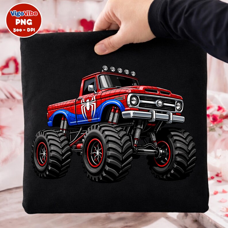May include: Black square pillow featuring a red, blue, and white monster truck design. The truck has large tires and a Spider-Man logo. The pillow is held by a person.