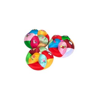 May include: Three colorful fabric balls with embroidered flowers and birds. The balls are made of different colored fabrics and are sewn together to form a sphere.