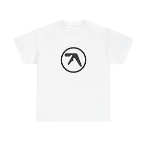 May include: White t-shirt with a black and white logo of the letter "A" in a circle.