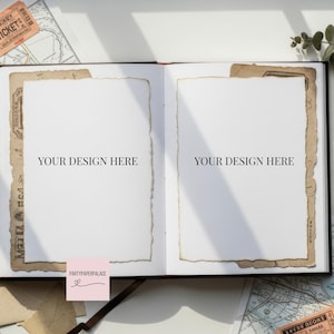 May include: An open black book with two blank white pages, each framed by aged paper. The text "YOUR DESIGN HERE" is printed on each page. A pink sticky note with the text "PARTYPAPERPALACE" is in the lower left corner.