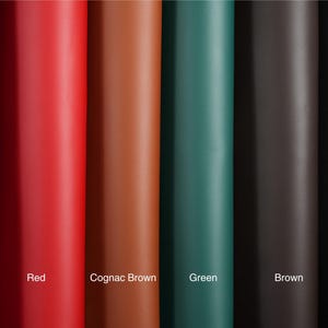 A top view of rolled top grain premium Italian leather, 4.5-5 oz, in various colors: brown, black, green, red, burgundy, and cognac brown—perfect for crafting projects.