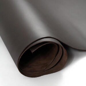 Partially unrolled roll of top grain premium Italian leather, 4.5-5 oz, brown leather perfect for crafting bags, wallets, and accessories.