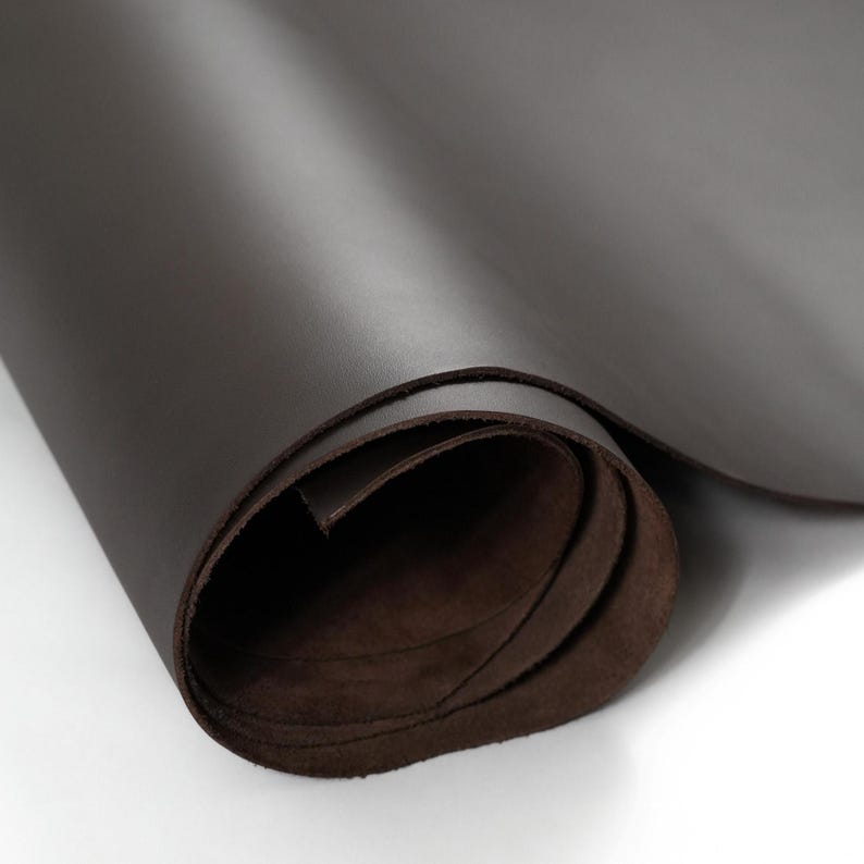 Partially unrolled roll of top grain premium Italian leather, 4.5-5 oz, brown leather perfect for crafting bags, wallets, and accessories.