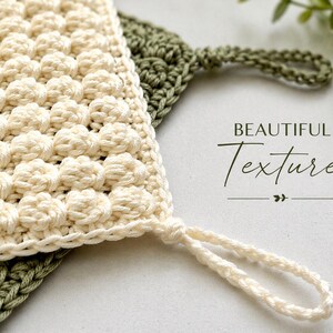 May include: Close-up of two handmade crochet washcloths. One is cream-colored with a textured, raised pattern and a loop for hanging. The other is olive green with a simple stitch pattern. The words "BEAUTIFUL Texture" are written in script.