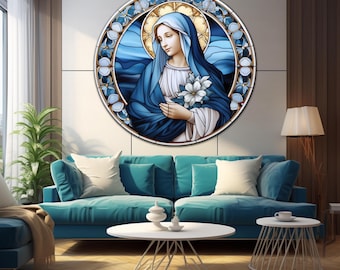 May include: A circular stained glass wall art piece featuring a depiction of a figure with a blue head covering and robe, holding white flowers. The artwork is framed by a decorative border of blue and white floral motifs against a golden halo.