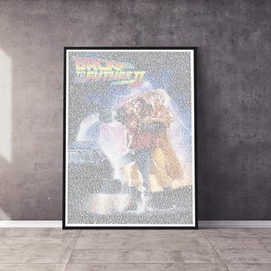 May include: A black and white poster of the film "Back to the Future Part II" with the film's title in large letters at the top. The poster features a scene from the movie with Marty McFly and Jennifer Parker standing in front of a DeLorean time machine.