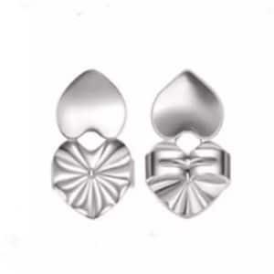 May include: A pair of silver heart-shaped earring backs. The backs are designed with a smooth heart on top and a textured heart on the bottom.