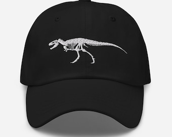 May include: A black baseball cap with a white embroidered dinosaur skeleton design.