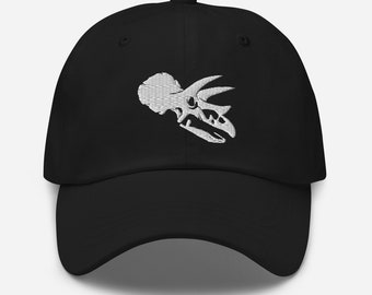 May include: A black baseball cap with a white embroidered dinosaur skull design.