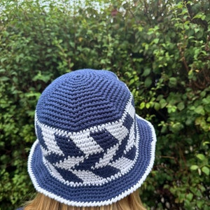 May include: A blue and white crocheted bucket hat with a checkered pattern.
