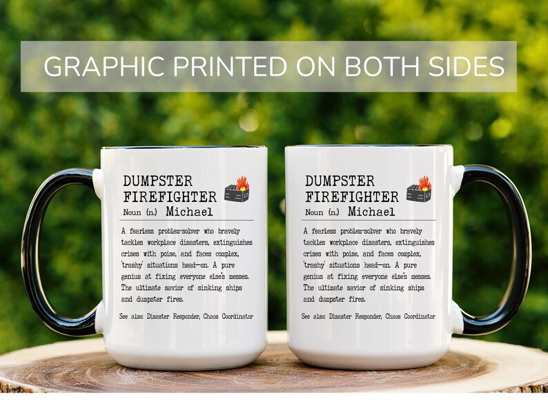 May include: Two white ceramic mugs with black handles. Both mugs feature a black and white graphic print with the text "Dumpster Firefighter" and the name "Michael".