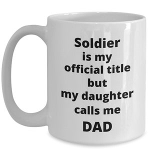 May include: White ceramic coffee mug with black text that reads "Soldier is my official title but my daughter calls me DAD".