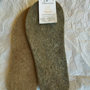 May include: Two pairs of alpaca insoles, one brown and one gray, with a tag that reads "Alpaca Insoles" and "Tahoma Vista Fiber Mill". The tag lists sizes for women and men.