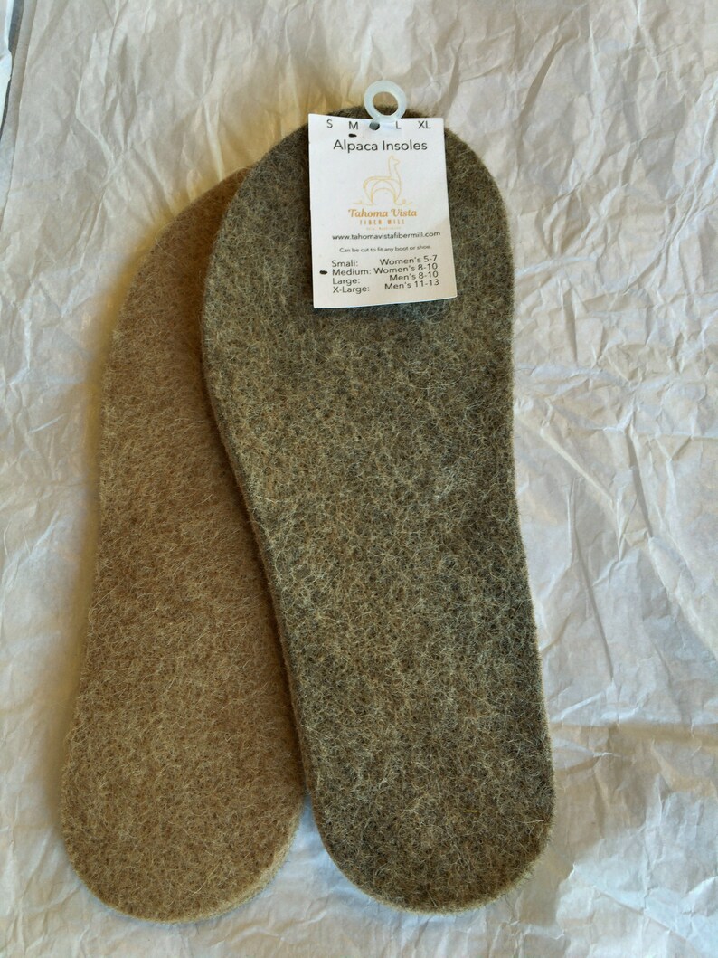 May include: Two pairs of alpaca insoles, one brown and one gray, with a tag that reads "Alpaca Insoles" and "Tahoma Vista Fiber Mill". The tag lists sizes for women and men.