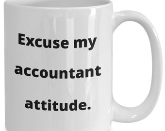 May include: White ceramic coffee mug with black text that reads "Excuse my accountant attitude."