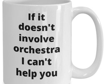Op de afbeelding: Witte keramische koffiemok met zwarte tekst die luidt: "Als het geen orkest betreft, kan ik je niet helpen".