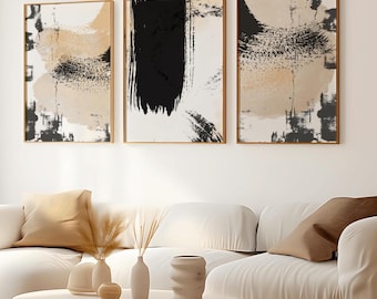May include: Three framed abstract art prints with black and beige brushstrokes on a white background. The prints are hanging on a white wall above a white couch with beige pillows.