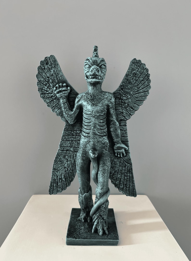 May include: A green, winged, humanoid statue with a snake wrapped around its legs. The statue has a reptilian head with a pointed horn on top. The statue is standing on a square base.