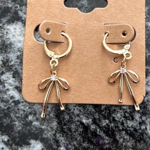 Gold bow huggies | Small gold huggies | Delicate bow charm earrings