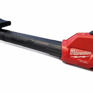May include: A red and black leaf blower with the "Milwaukee" logo. The blower has a curved nozzle and a handle. The word "FUEL" is printed on the side. The leaf blower is designed for outdoor use.