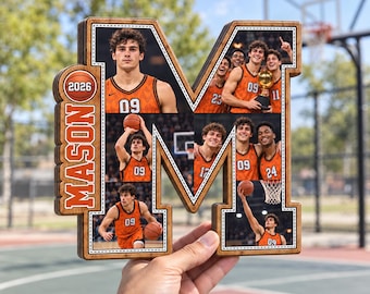 May include: A wooden letter M-shaped photo collage frame featuring multiple basketball-themed images of a player wearing an orange jersey with the number 09. The frame includes the name MASON and the year 2026 printed in orange on the left side.