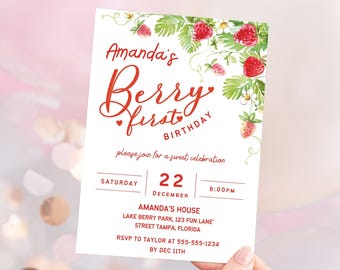 May include: A white invitation with red text and a strawberry theme. The invitation reads "Amanda's Berry First Birthday" and includes details for a sweet celebration on Saturday, December 22nd at 8:00 PM. The invitation also includes the address for Amanda's House and RSVP information.