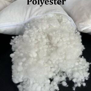 May include: Close-up of a white pillow filled with white polyester fiberfill. The pillow is open, revealing the filling. The text "Down Alternative Polyester" is visible above the pillow.