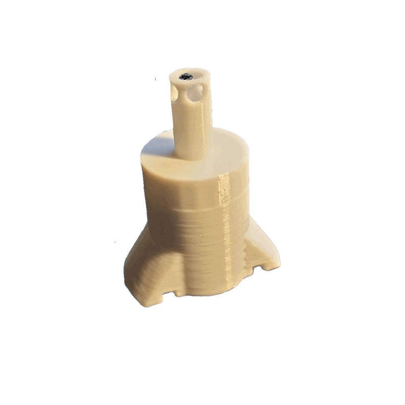May include: A beige, 3D-printed object with a cylindrical body and a flared base. It has a vertical, narrow tube extending upwards from the top. The object appears to be a custom-made component or part.