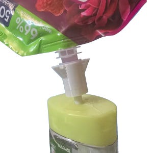 May include: A white plastic dispenser spout is inserted into a green and pink pouch. The spout is connected to a light green bottle. The pouch has text that reads "69%" and "50". The bottle has text that reads "250".