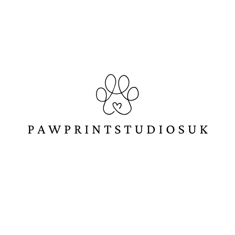 a black and white logo for pawprintstudisuk