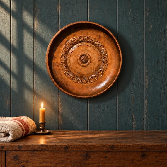 An actual 1944 Norwegian folk art wall plate — hand-carved with Scandinavian rosemaling-style motifs and a documented wedding gift provenance, making it a one-of-a-kind antique artifact.