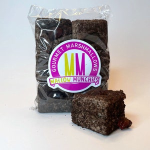 May include: A bag of gourmet marshmallows with a pink and yellow logo that says "Gourmet Marshmallows MM Mallow Munchies". The marshmallows are covered in a dark brown chocolate coating.