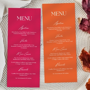 May include: Two menu cards, one magenta and one orange, with white script. The menus list appetizers, starters, main courses, and desserts. Dishes include Bruschetta, Caesar salad, and pan-seared chicken. The cards are on a textured surface.