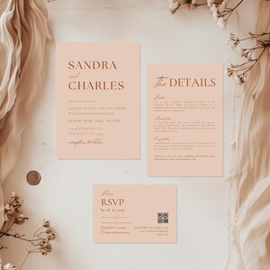 May include: A peach-coloured wedding invitation suite with the names Sandra and Charles, the date 20th August 2024, and the time 5 PM. The invitation includes details about the wedding ceremony and reception, as well as an RSVP card with a QR code.
