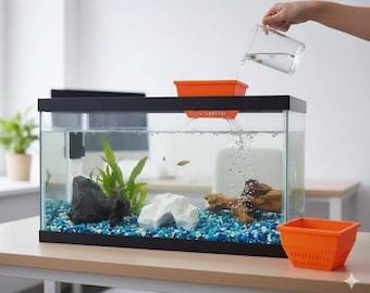 May include: A rectangular glass aquarium with a black frame, filled with water, gravel, and aquatic plants. An orange filter is on top, with water being poured into it. The tank contains small fish and decorative elements. The aquarium sits on a light brown table.