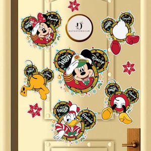 May include: A collection of Disney character-themed Christmas decorations, including Mickey Mouse, Minnie Mouse, Donald Duck, and Pluto. Each character is depicted in festive attire, surrounded by decorative lights and snowflakes. The decorations are affixed to a light-colored door.