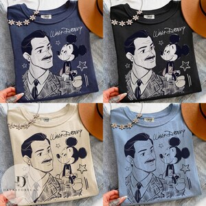 May include: Four t-shirts in navy, black, beige, and light blue, each featuring a graphic of Walt Disney and Mickey Mouse. The text "Walt Disney" is above the graphic. Each shirt has a floral necklace.